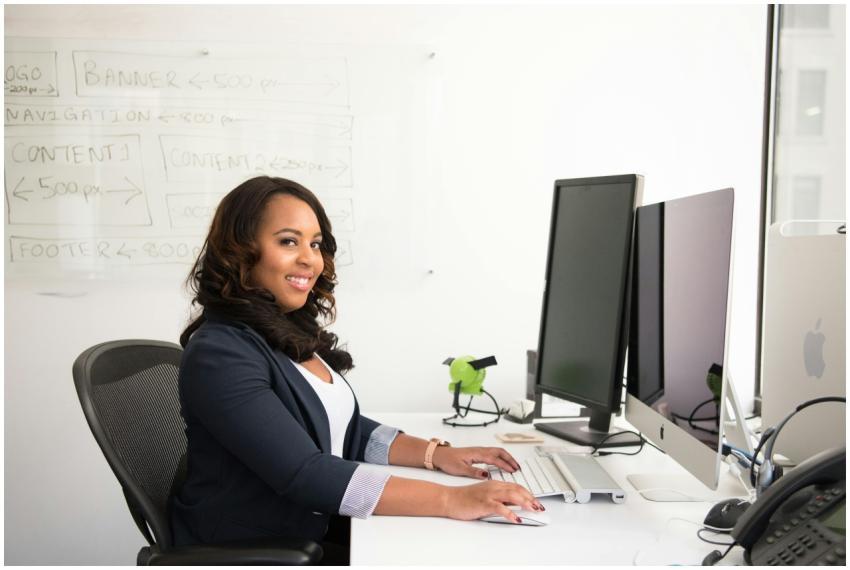 Confident businesswoman seated at her desk in an o