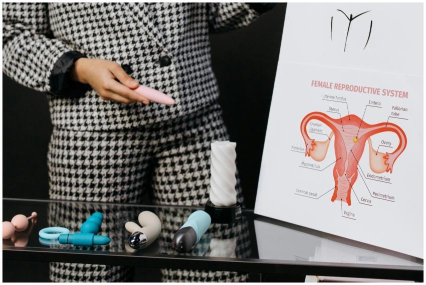 A person demonstrates various sex toys alongside a