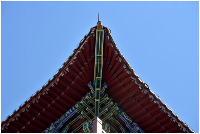 Close-up of a traditional Asian roof against a cle