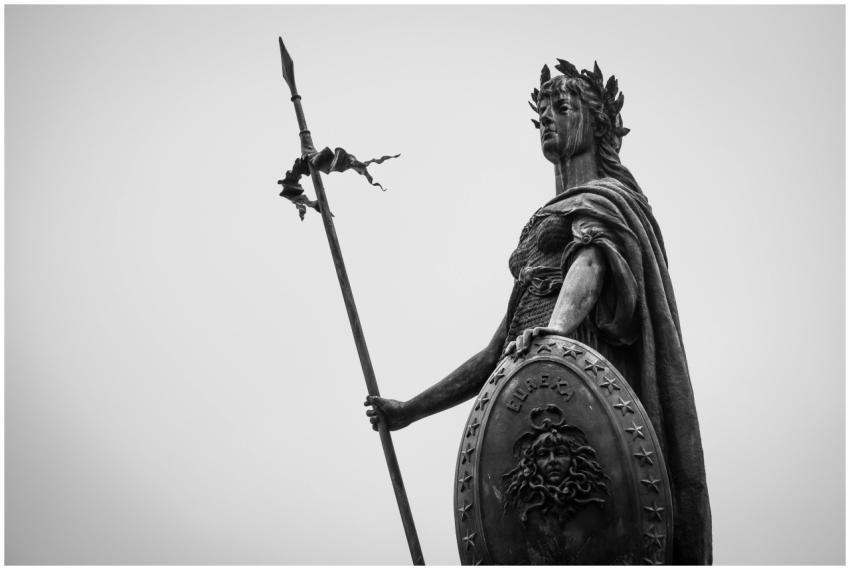 A monochrome photograph showcasing a classic statu