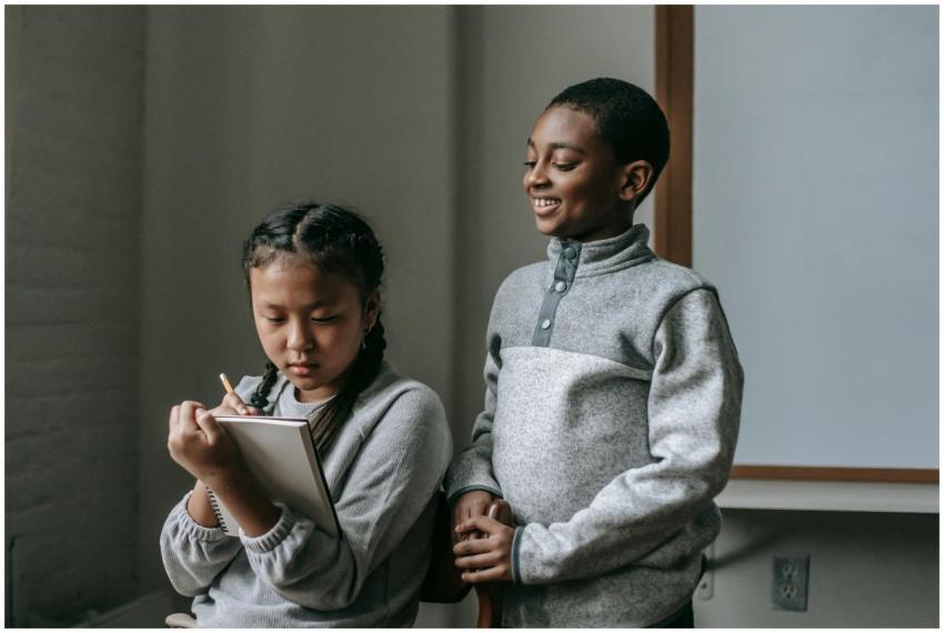 Two children engaged in a classroom activity, one