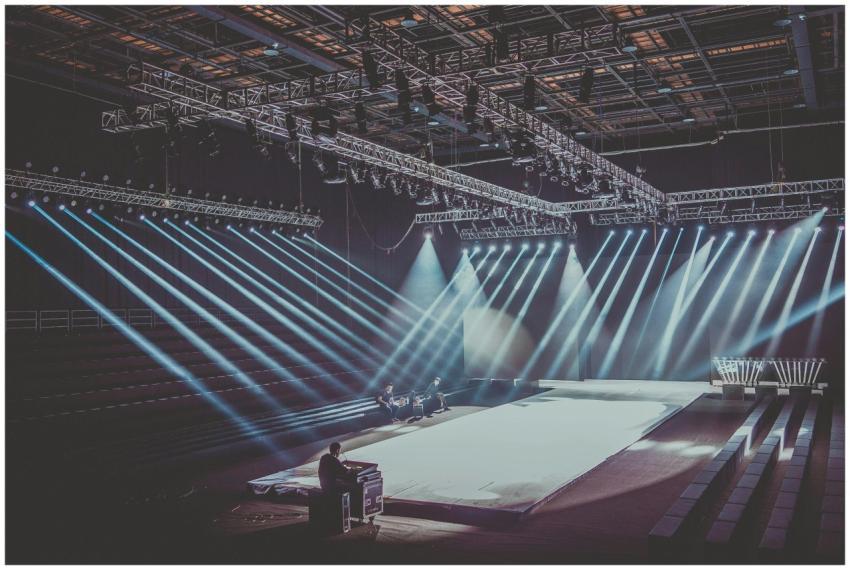 An expansive indoor stage with dramatic lighting s