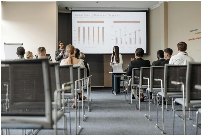 Business conference attendees listen to a presenta