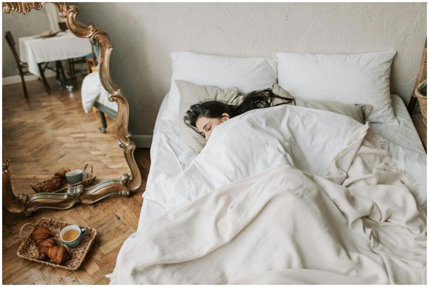 A woman peacefully sleeping in a cozy bed with cro