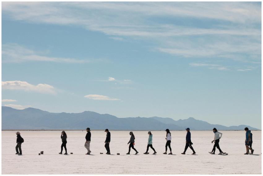 A group of people walking across the vast Salinas