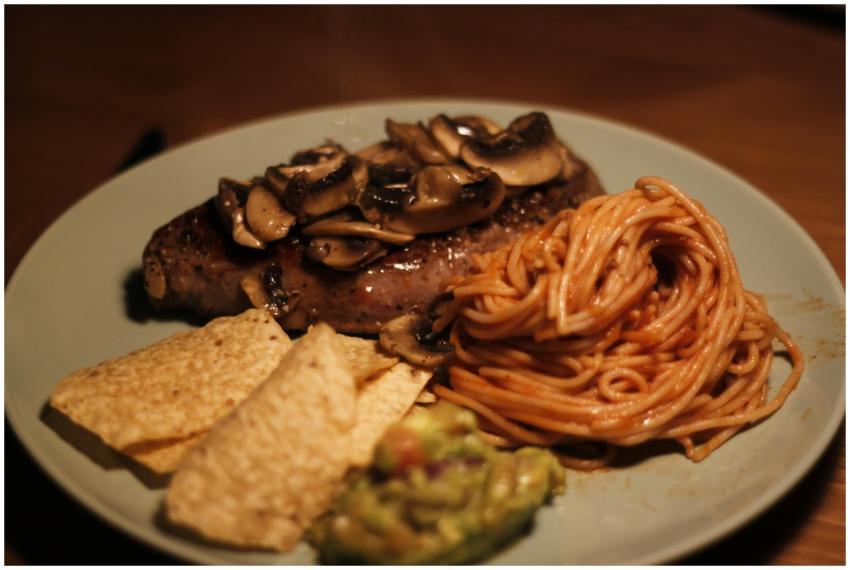 A gourmet beef dinner featuring steak with mushroo