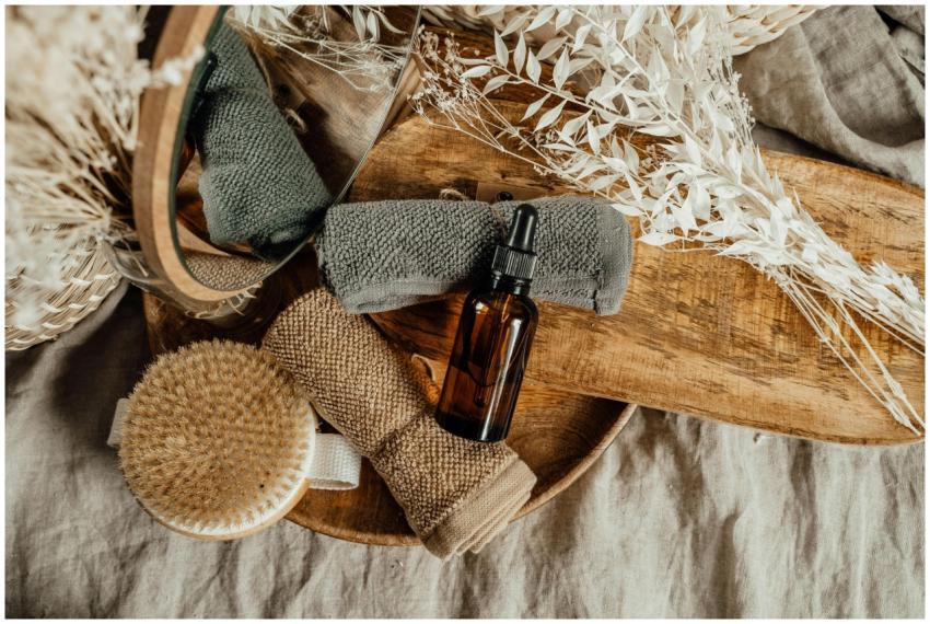 A serene spa setting with essential oil, towels, a