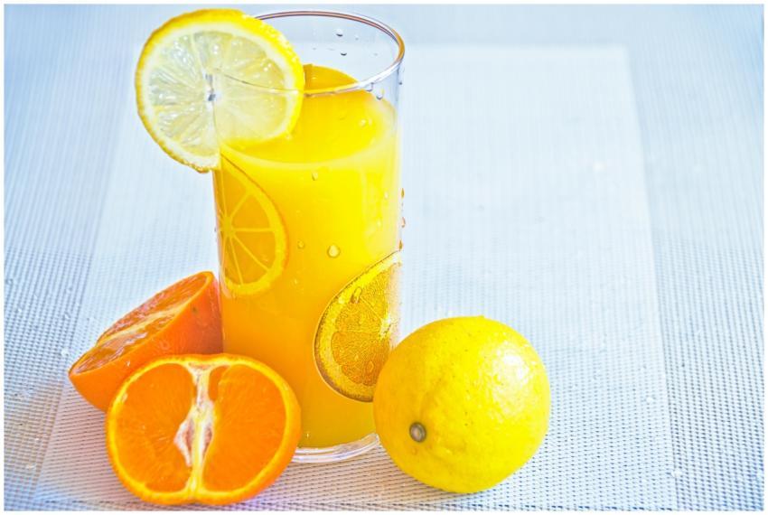 Vibrant citrus juice in a glass with fresh orange