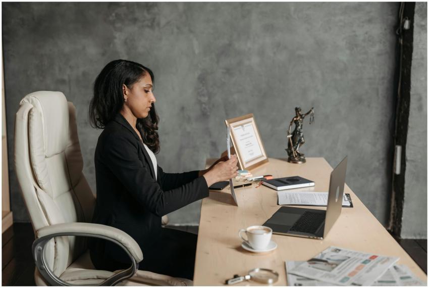 A focused businesswoman in formal attire works at