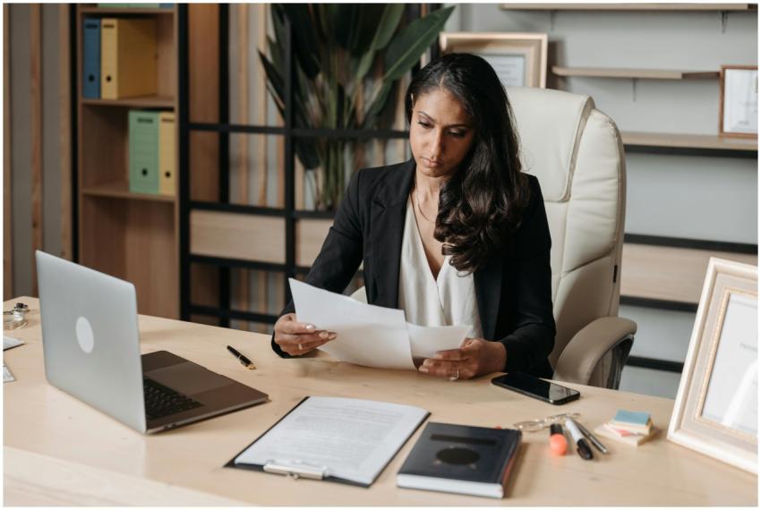 Business woman focused on paperwork at office desk