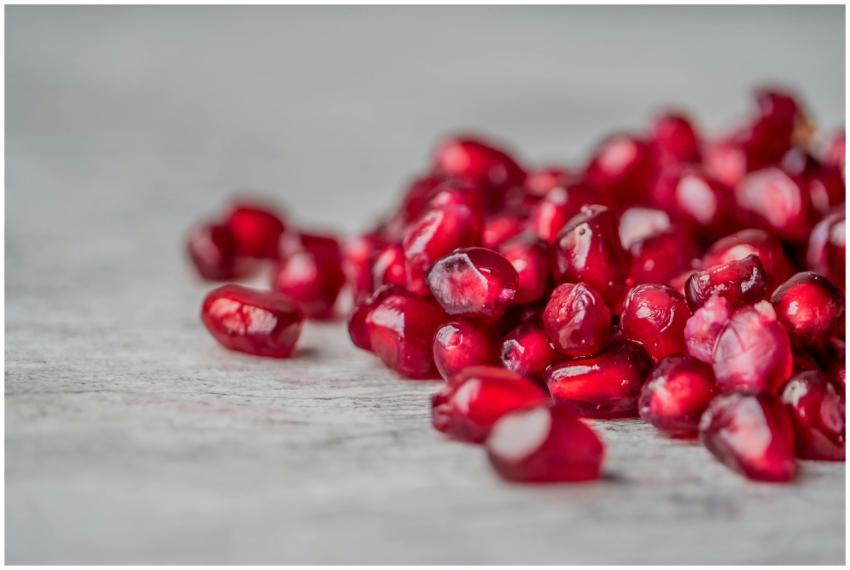 Vivid close-up of juicy red pomegranate seeds scat