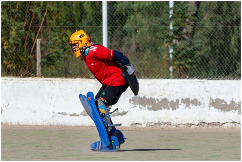 Dynamic field hockey player in full protective gea
