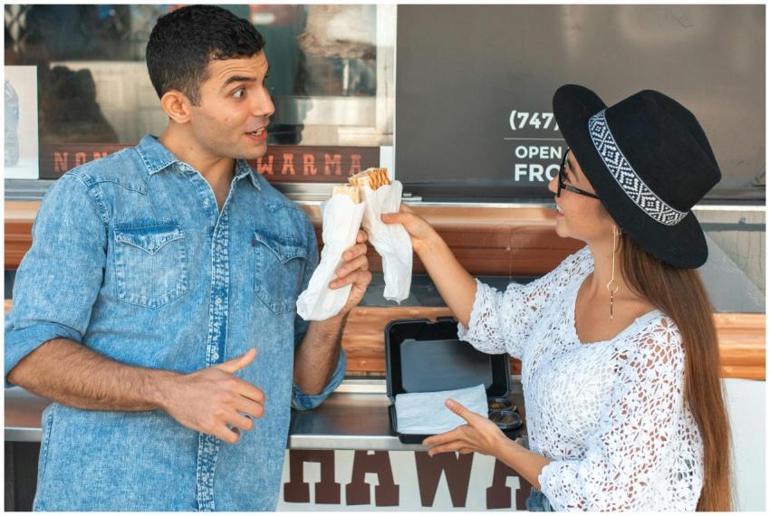 Cheerful grimacing couple in casual clothes clinki