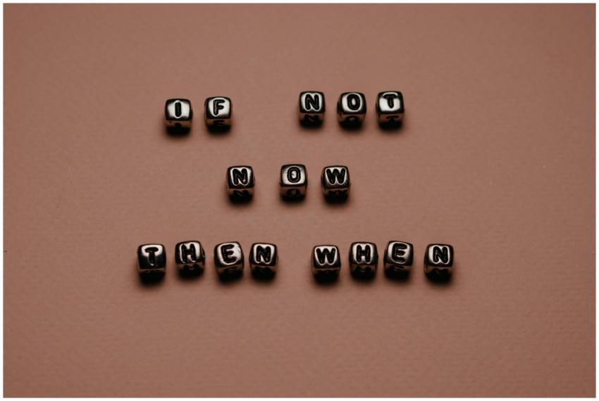 Metal letter cubes spelling 'If not now, then when