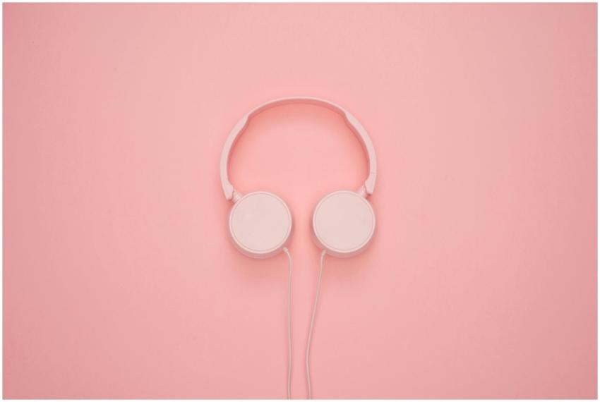 Aesthetic pink headphones on a pastel background,