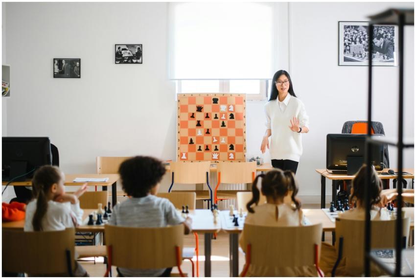 A teacher instructs students in a chess classroom,