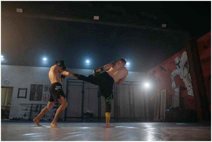 Two male athletes sparring in a martial arts studi