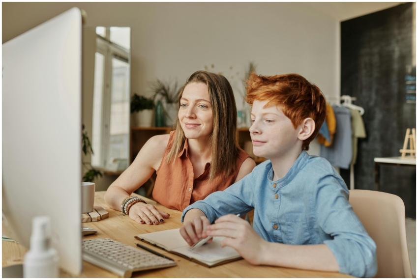 A mother and her son engaging in online learning a