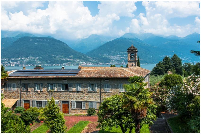 Historic building with bell tower and mountain vie