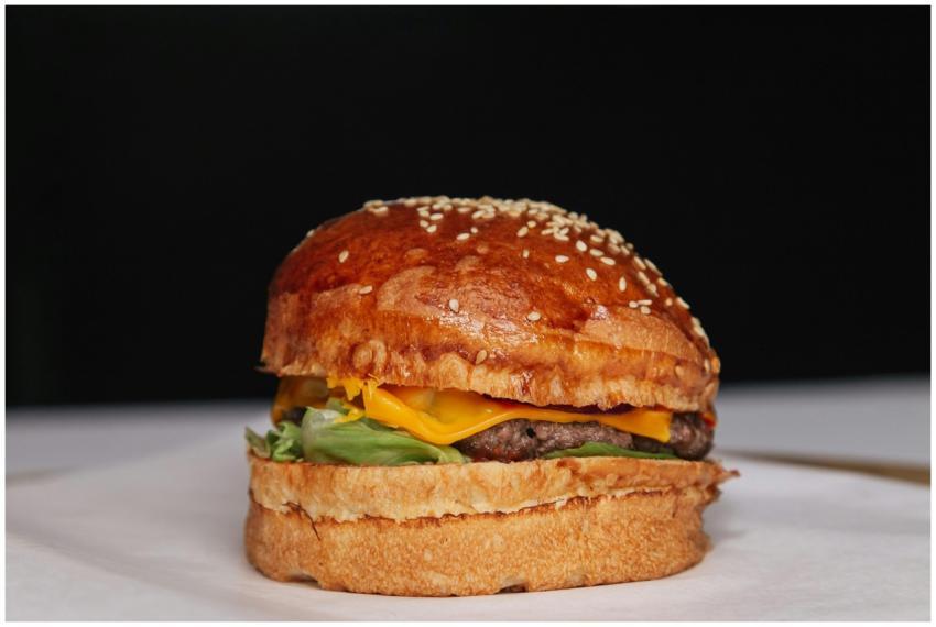 Mouthwatering cheeseburger with a sesame seed bun,