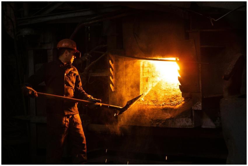 Blue-collar worker managing furnace in an industri
