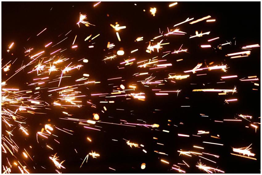 Close-up view of vibrant sparkler sparks illuminat