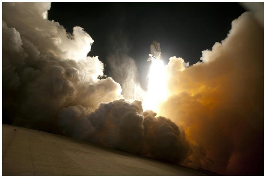 A dramatic image of a space shuttle launching into