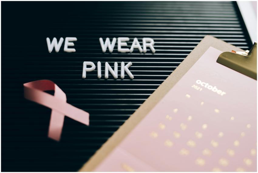 Pink ribbon, calendar, and board with 'We Wear Pin