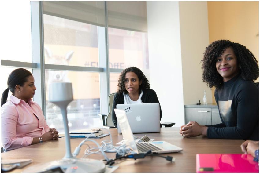 Three professional women engaged in a lively discu