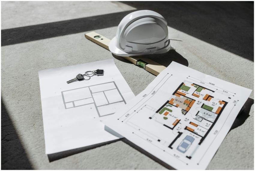 Architectural floor plans with helmet and keys on