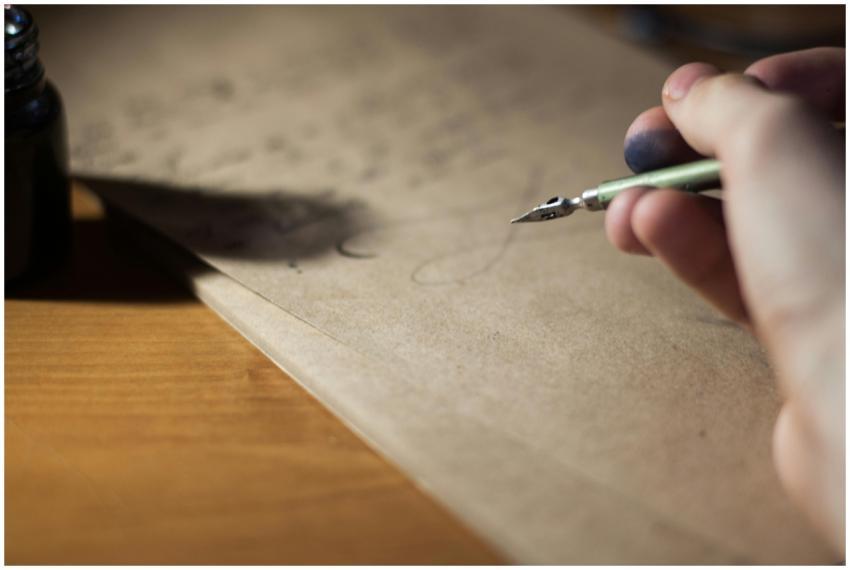 Close-up of a hand writing with a fountain pen on