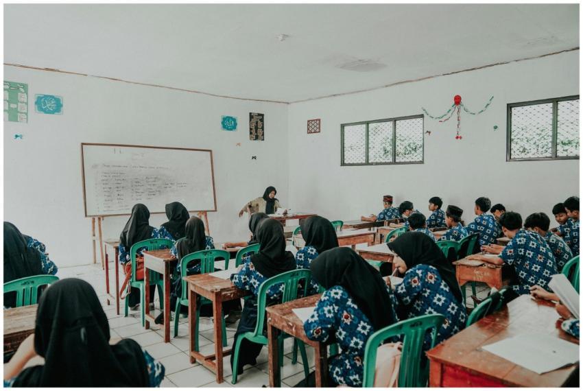 Students in traditional attire attend a lesson in