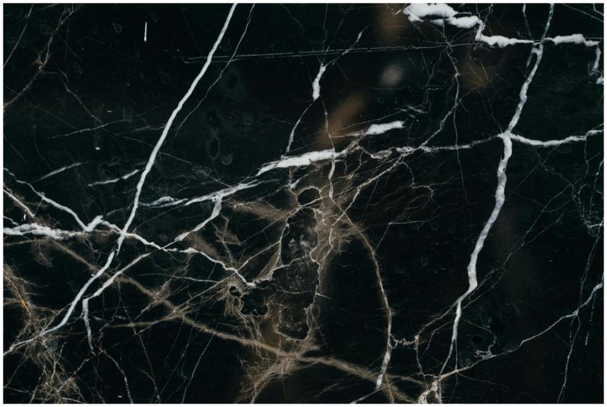 Close-up view of a black marble texture, showcasin