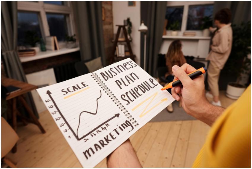 Person holding a notebook with planning details an