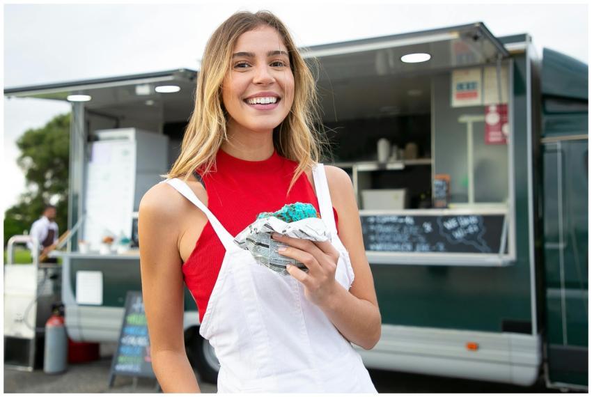 Cheerful woman in red top enjoying blue ice cream