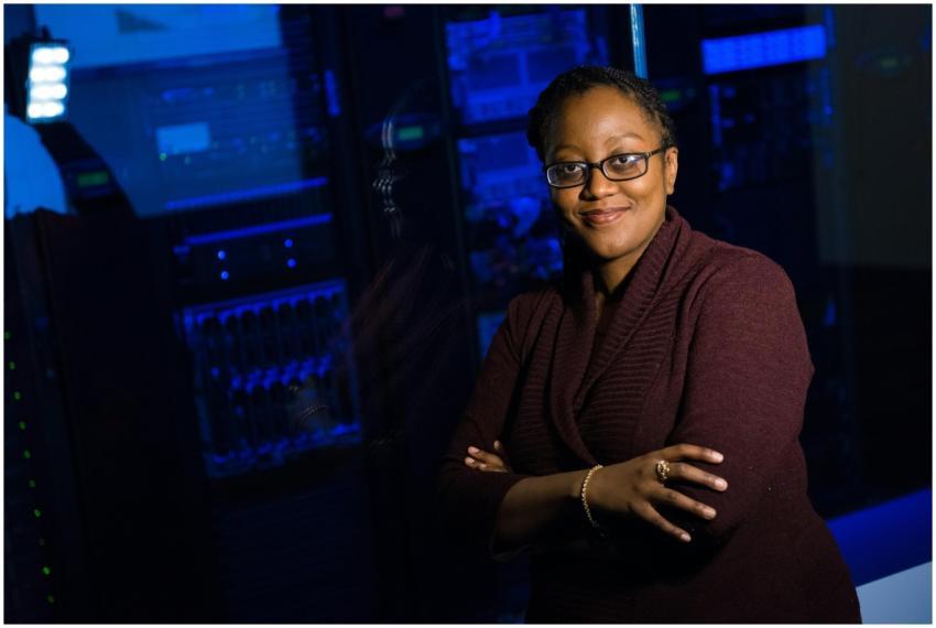 Confident woman in data center, showcasing tech ex