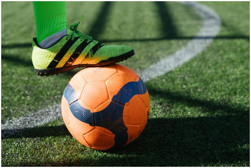 Dynamic shot of a soccer player's foot on a vivid