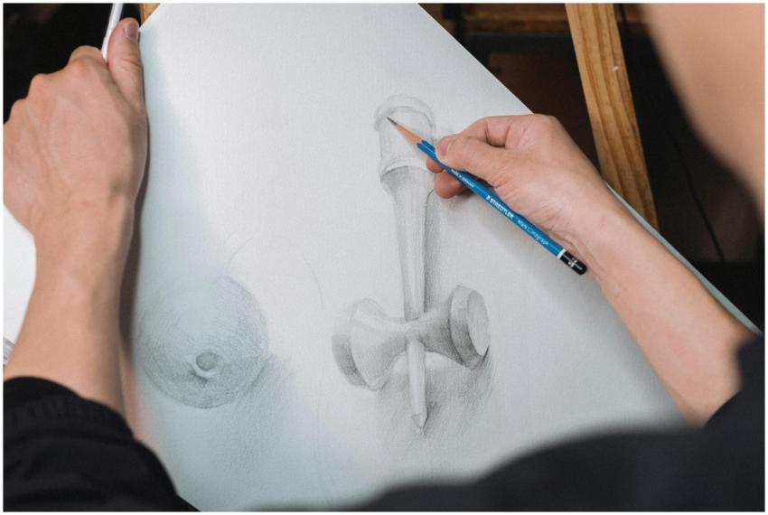 Close-up of an artist sketching a geometric object