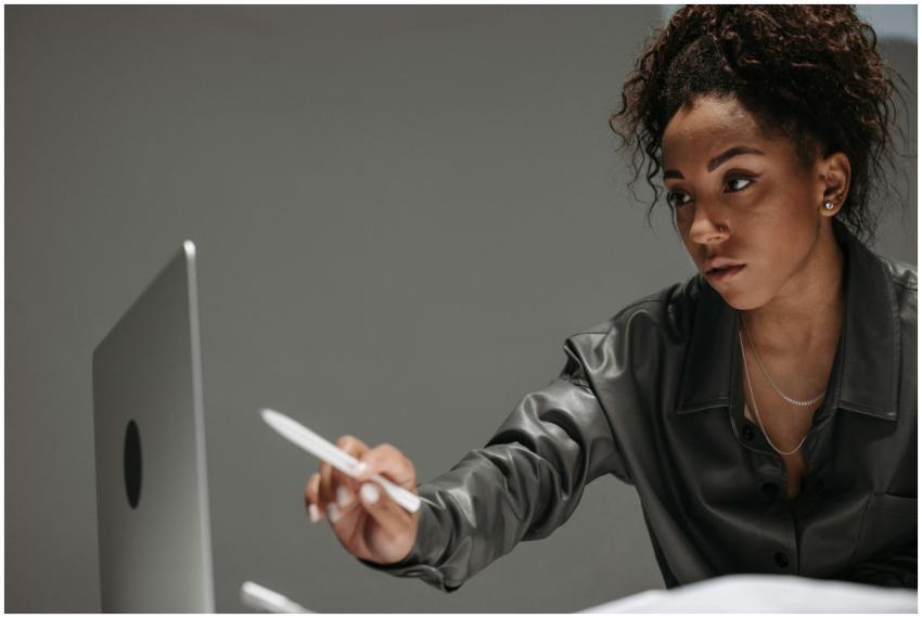 Young professional woman with curly hair working i