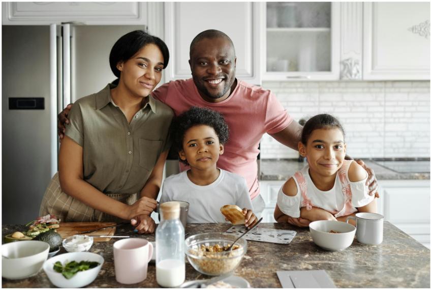A joyful family of four smiling together at the ki