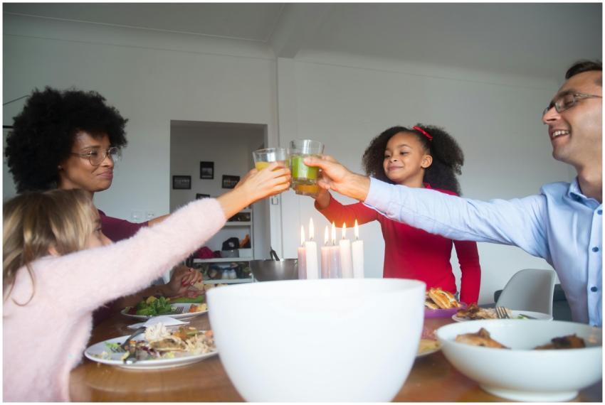 A happy family toasting at home with drinks around