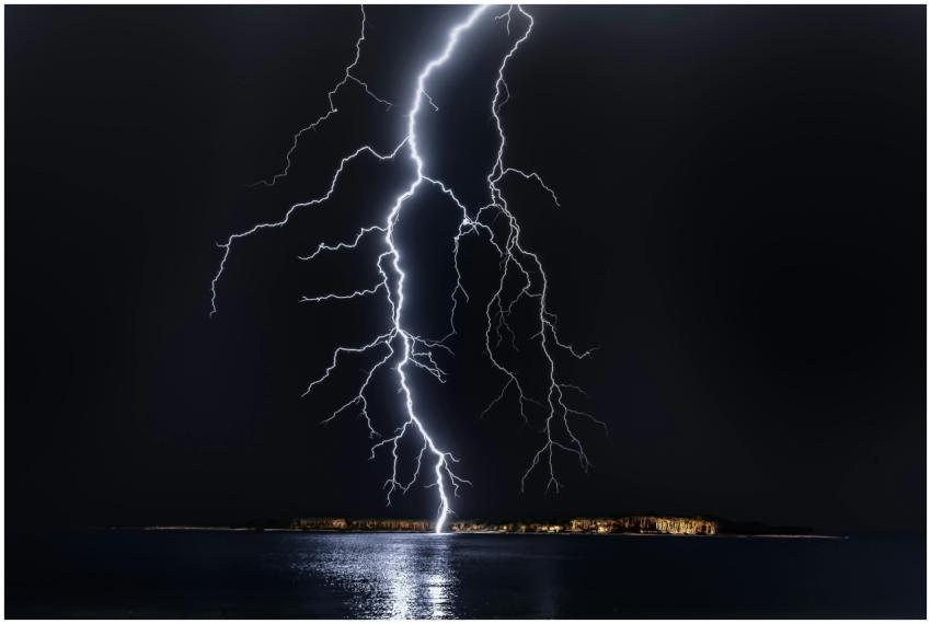 Dramatic lightning bolt over the ocean at night, i