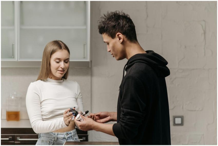 A young couple checking blood sugar levels using a