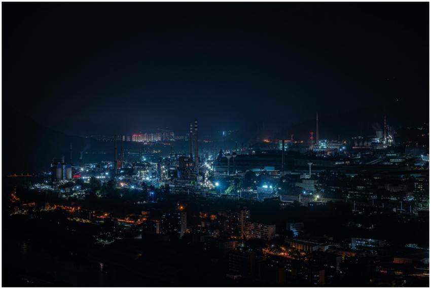 A vibrant cityscape of industrial buildings glowin