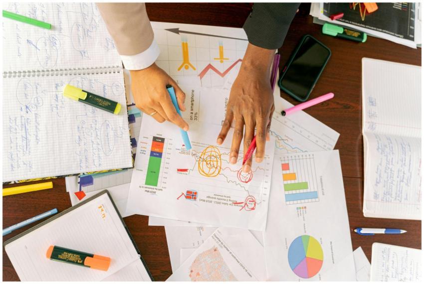 Top view of diverse professionals analyzing busine