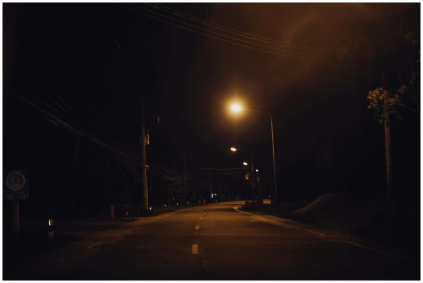 A serene nighttime street scene with glowing stree