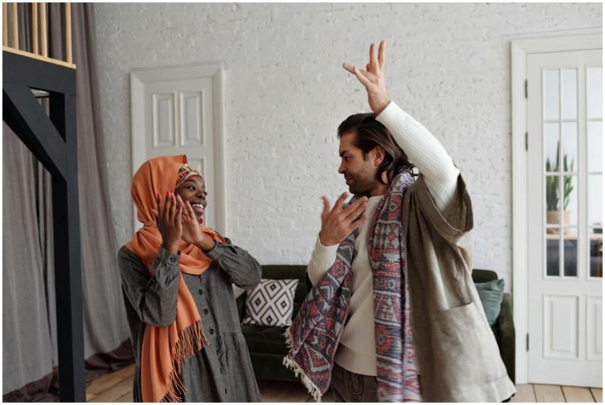 A happy multiracial couple dancing and celebrating
