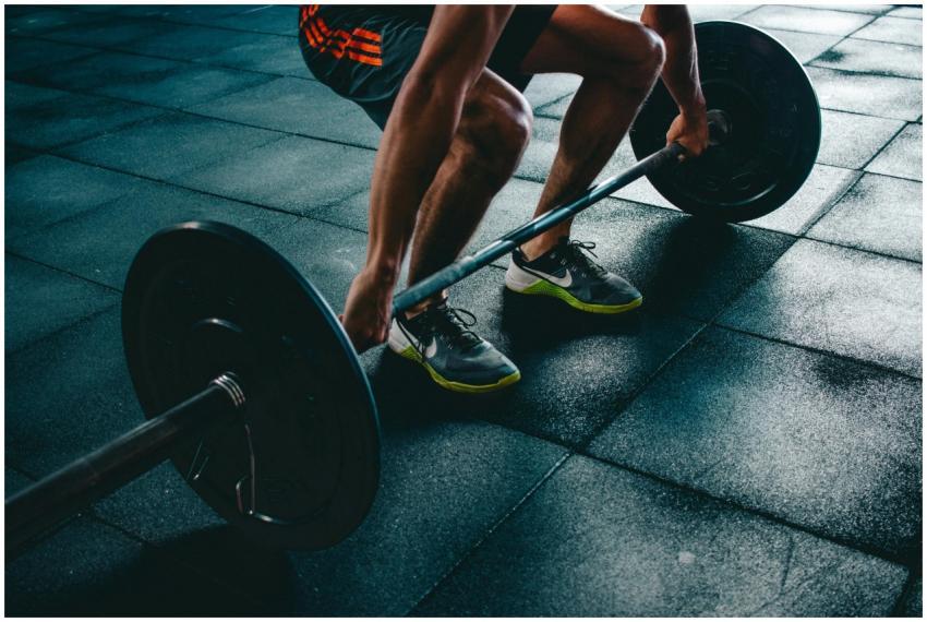 Man performing a deadlift exercise in a gym, demon