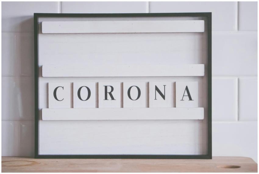 A framed sign with the word 'Corona' on a tiled wa