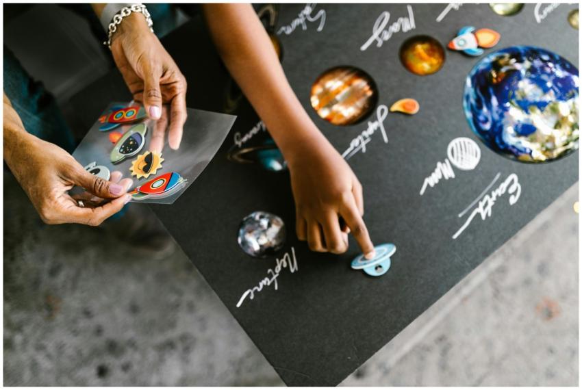 Close-up of a child learning the solar system usin